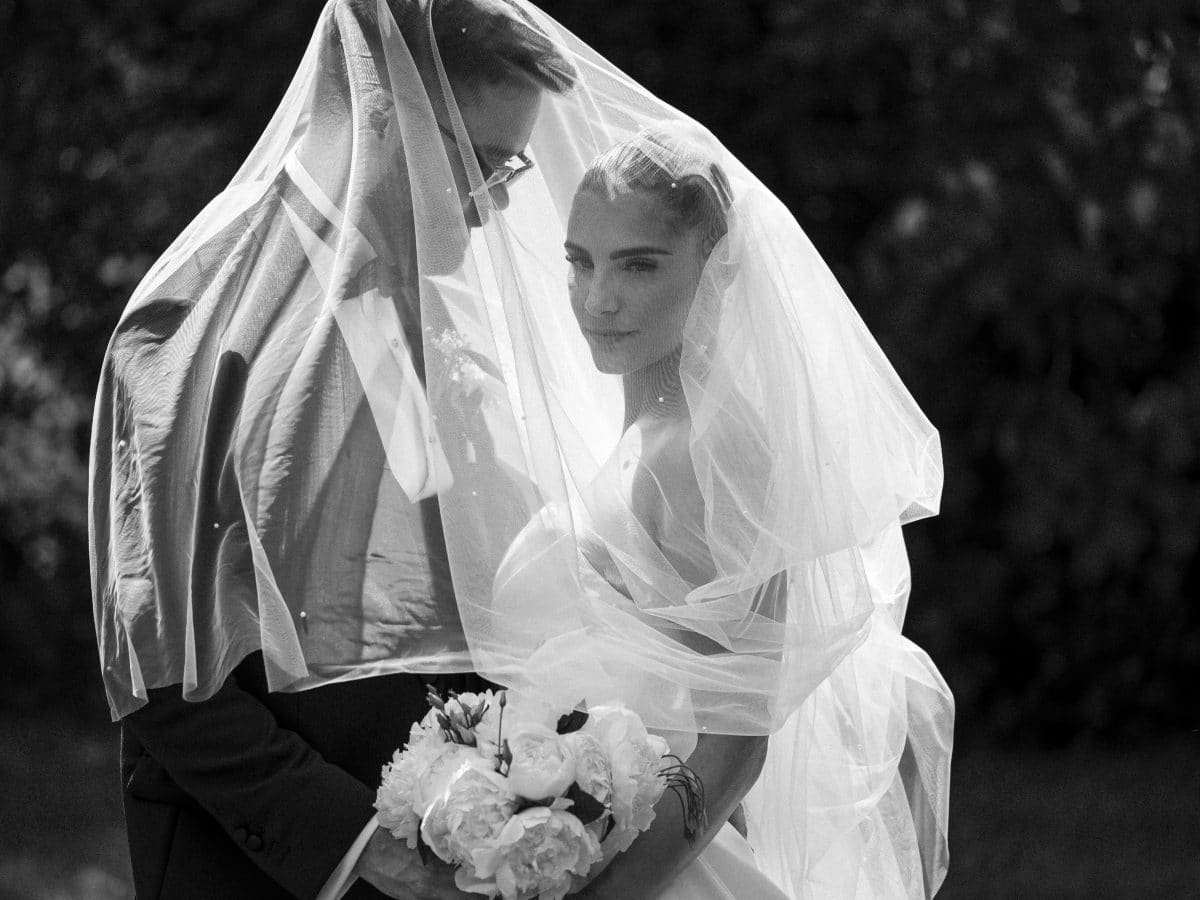 Black and white bride and groom under veil Black and white chic wedding champagne tower | wedding photographer Lymington New Forest | Elmers Court Wedding photographer new forest