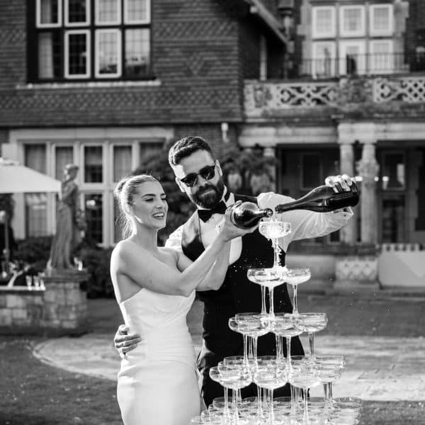Black and white bride and groom champagne tower | Elmers Court Wedding photographer new forest